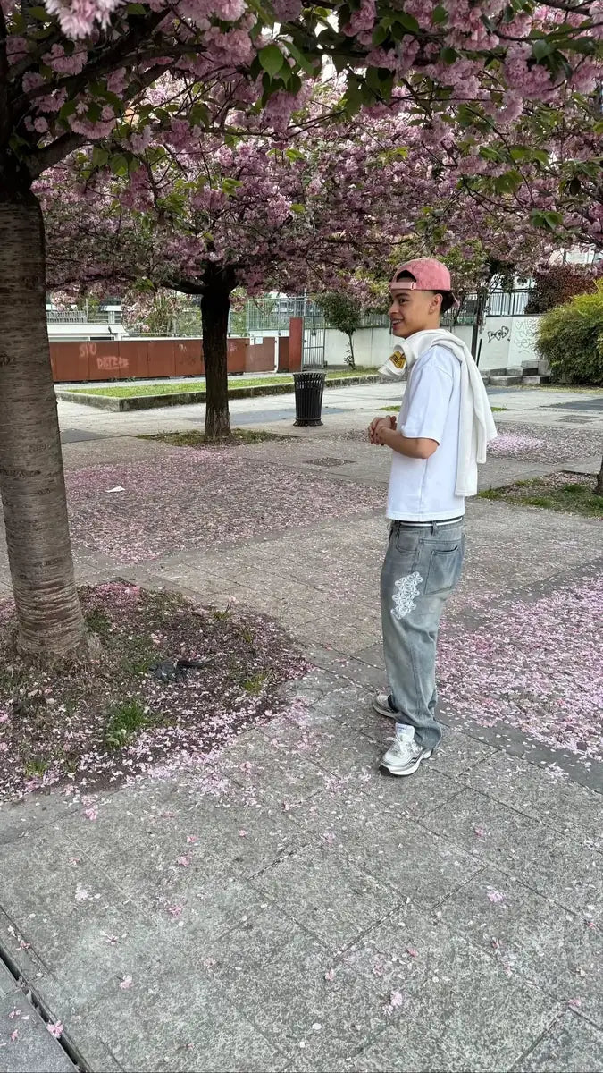 reda studio outfit: oversized white tee and embroidered washed jeans under cherry blossom